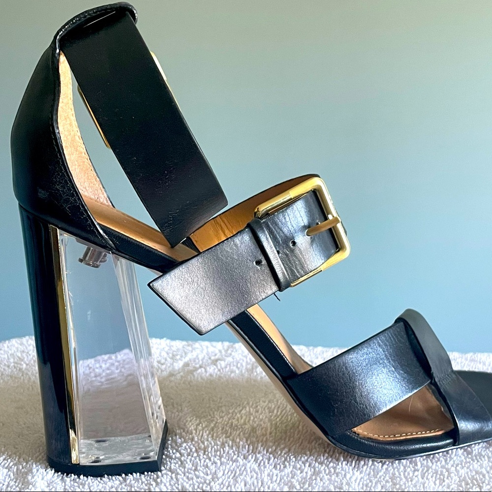 Calvin Klein- Black high heel. Heel is clear lined with a strip of gold.